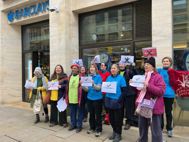 Oxford Climate Choir singing outside Barclays, NatWest and Santander