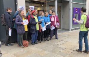 Oxford Climate Choir singing outside Barclays, NatWest and Santander