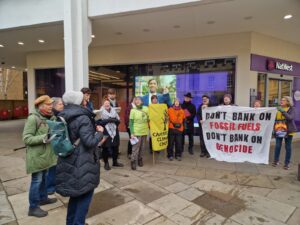 Cambridge Climate Choir singing outside Barclays, HSBC and NatWest