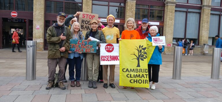 Cambridge Climate Choir outside Cambridge Railway Station – Stop Rosebank!